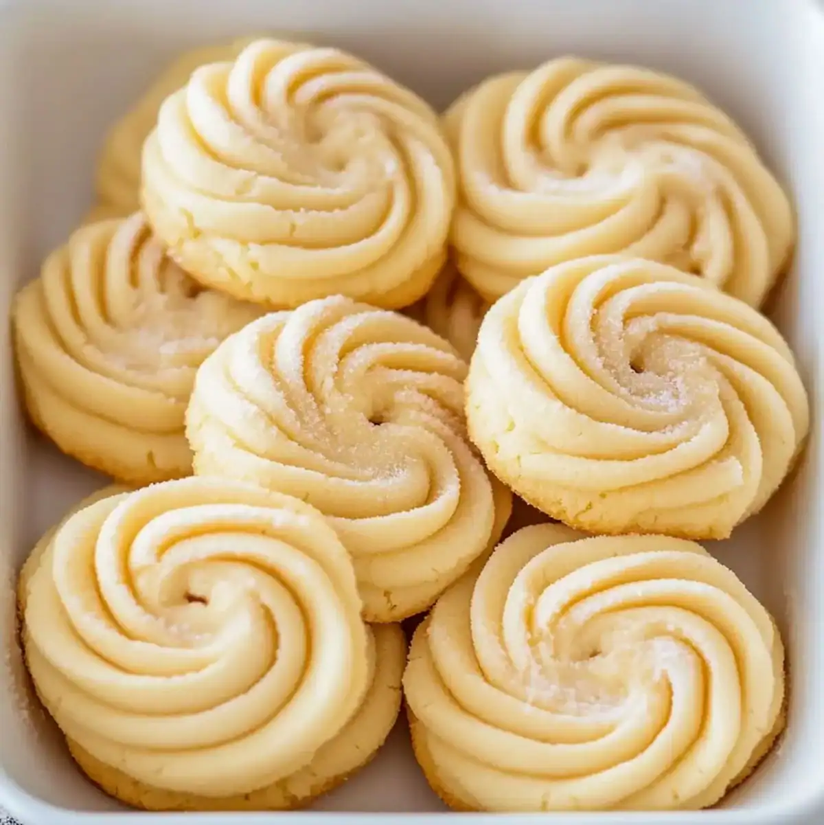 Classic butter swirl cookies on a white serving tray
