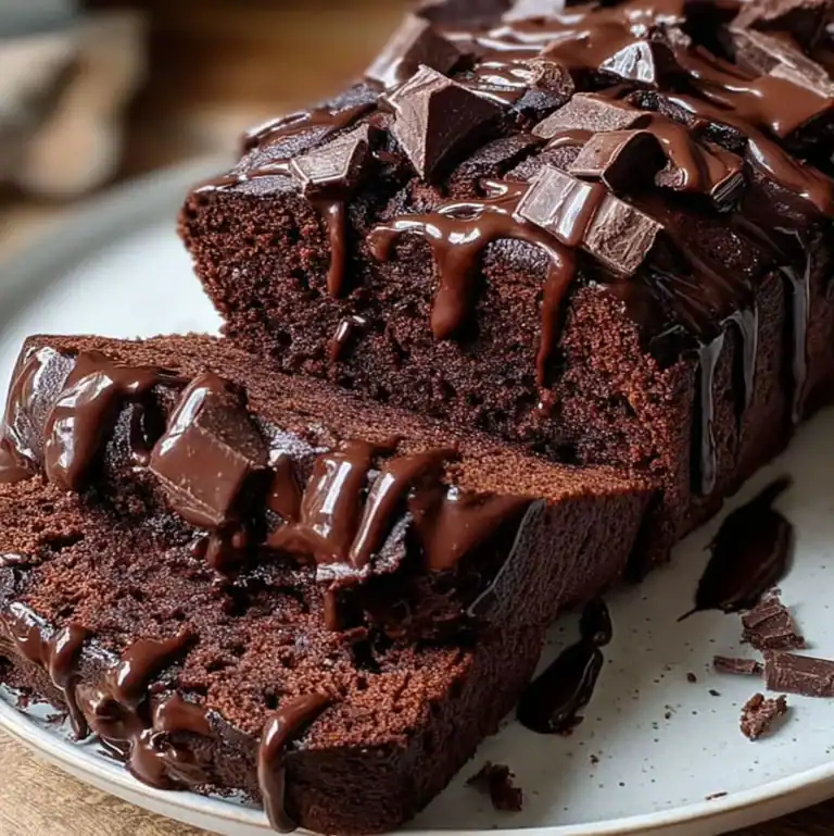 Moist dark chocolate loaf cake for dessert with ganache and chopped chocolate
