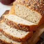 Easy Keto Bread for Low-Carb Sandwich Lovers 42 Keto bread loaf topped with seeds, sliced for meal prep