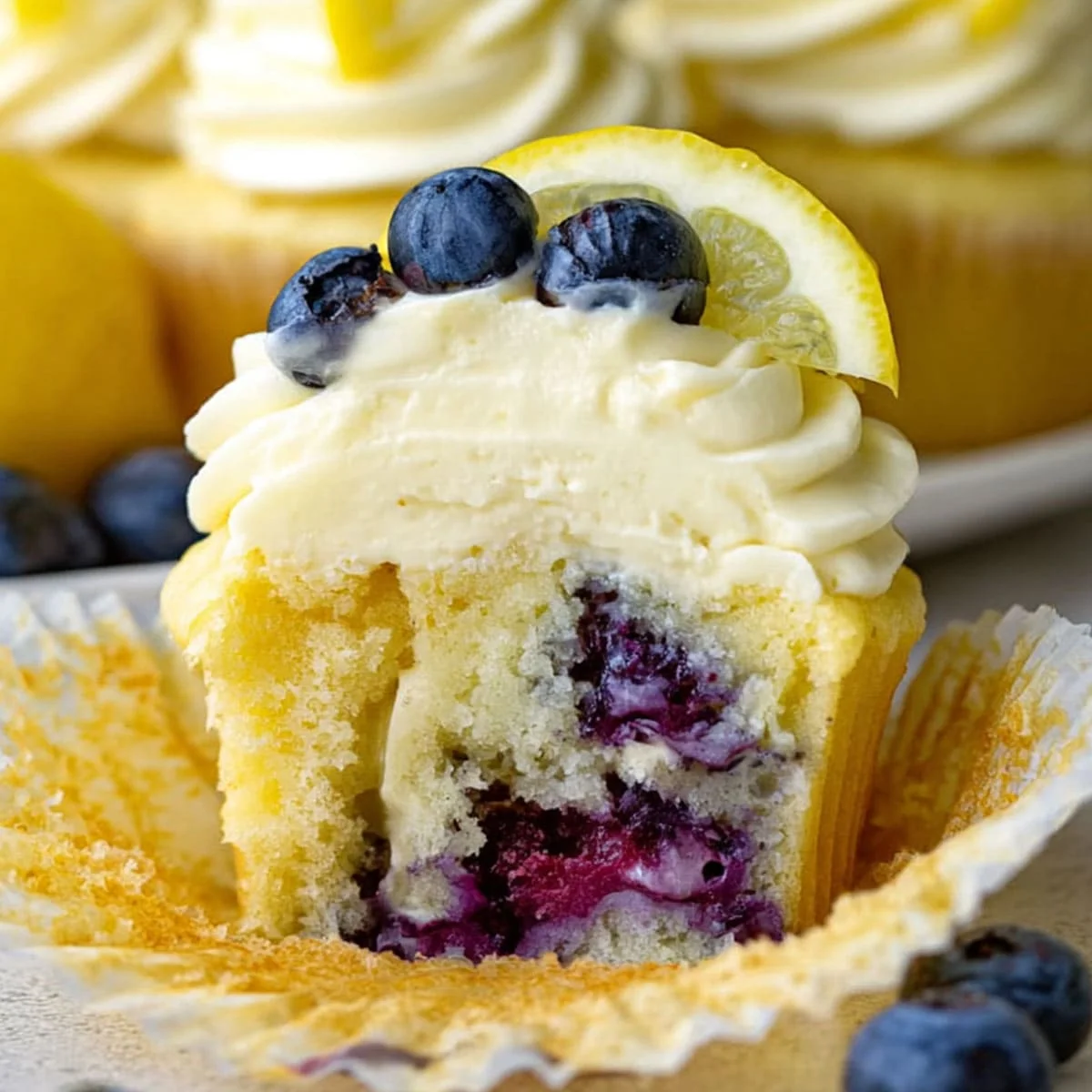 Lemon Blueberry Cupcakes – Perfect Summer Treat 117 Lemon blueberry cupcake sliced open to reveal juicy baked blueberries