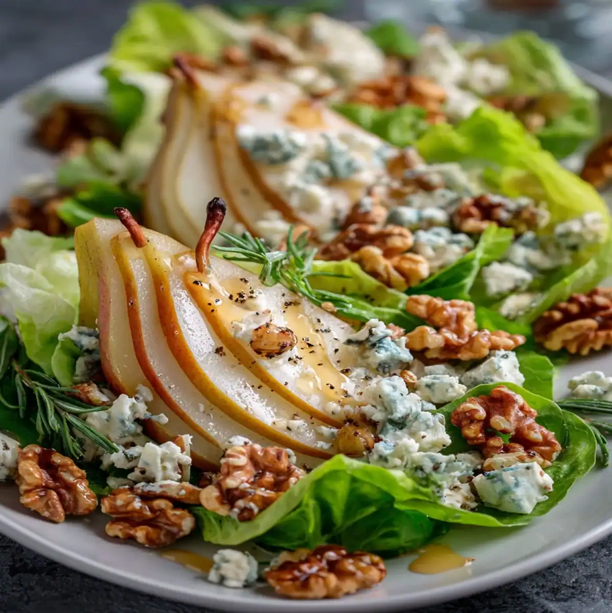 Summer salad featuring pears, blue cheese, leafy greens, and toasted walnuts