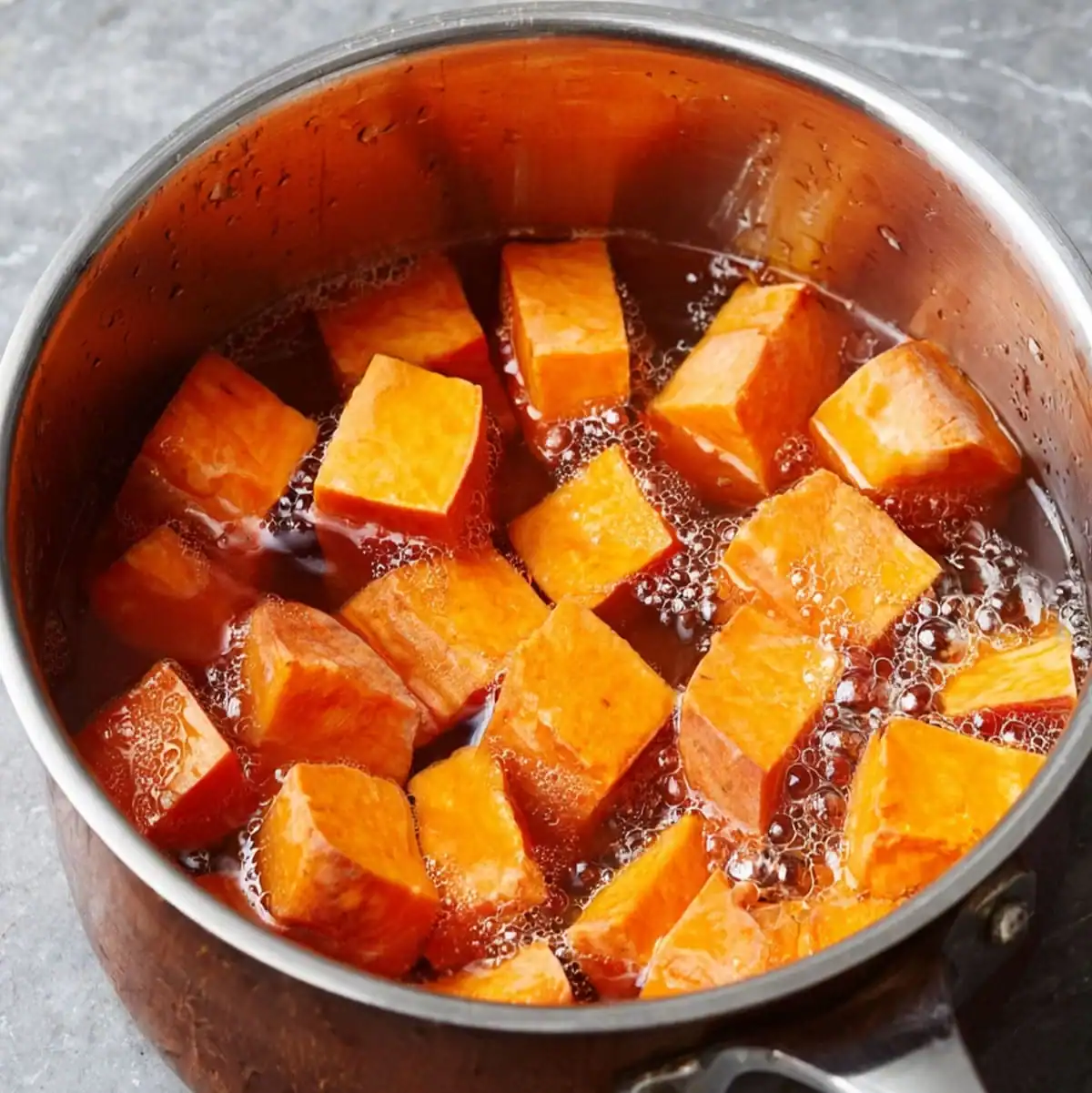 How to Boil Sweet Potatoes: The Complete Guide 1 Boiled sweet potato cubes cooking in a pot of water