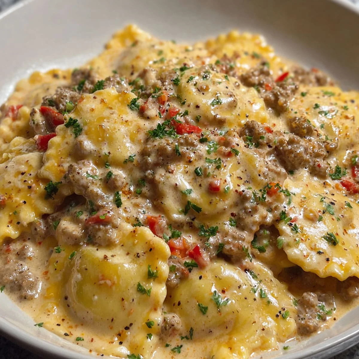 Creamy Cajun Sausage Ravioli – Rich Pasta Recipe Idea 72 Creamy Cajun Sausage Ravioli served in a white bowl with visible red peppers and herbs 🖊️ Caption:
