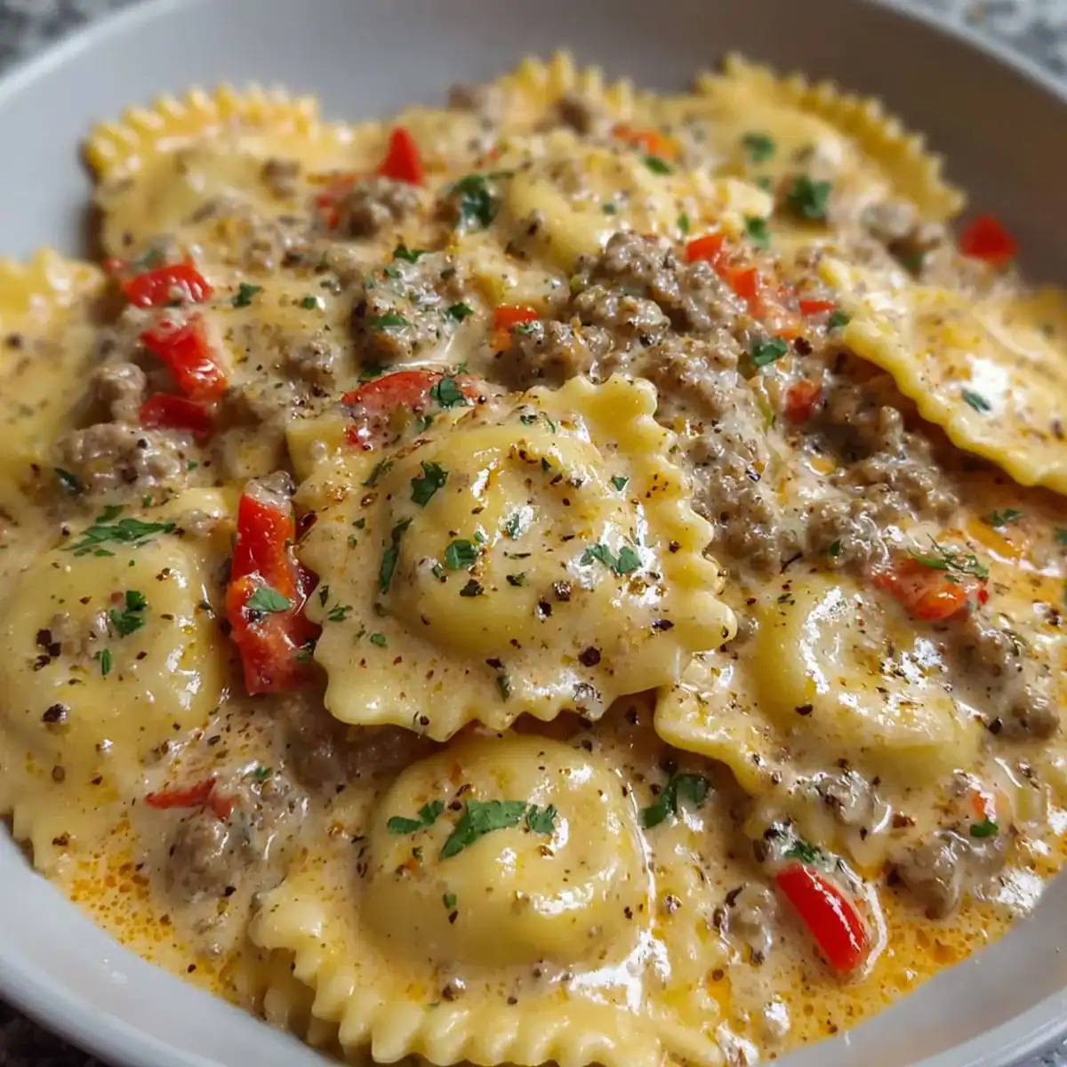 Creamy Cajun Sausage Ravioli – Rich Pasta Recipe Idea 71 Close-up of Creamy Cajun Sausage Ravioli topped with black pepper and fresh parsley