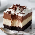 No Bake Peanut Butter Pie slice with chocolate pudding and Cool Whip topping