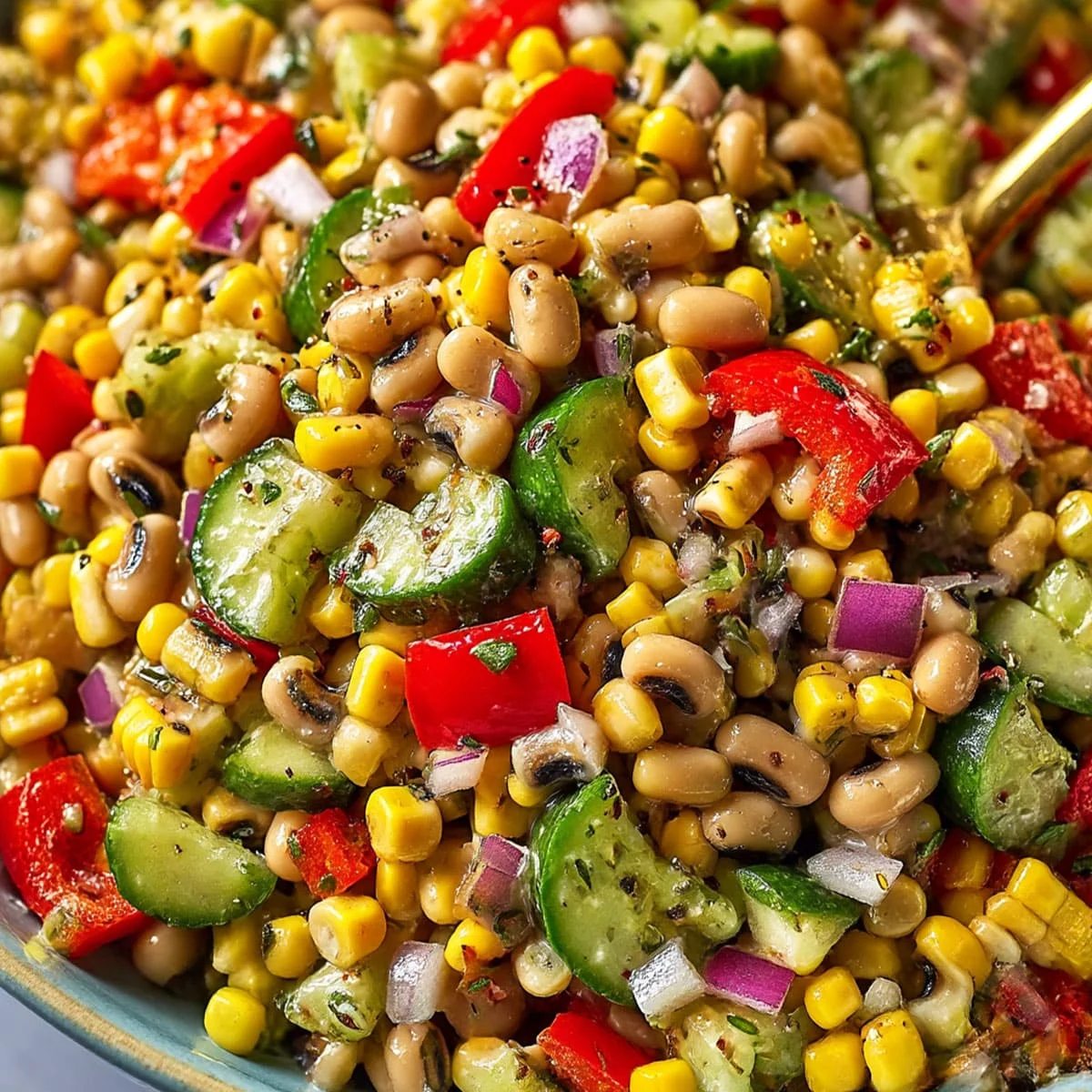 Marinated black eyed pea salad with corn, cucumber, and red pepper pieces