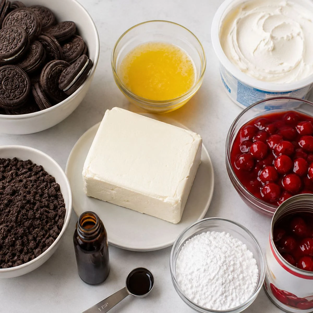 No Bake Cherry Cheesecake Dessert Recipe 58 No Bake Cherry Cheesecake Dessert Recipe ingredients with Oreo cookies, cream cheese, whipped topping, butter, powdered sugar, vanilla, and cherry pie filling.